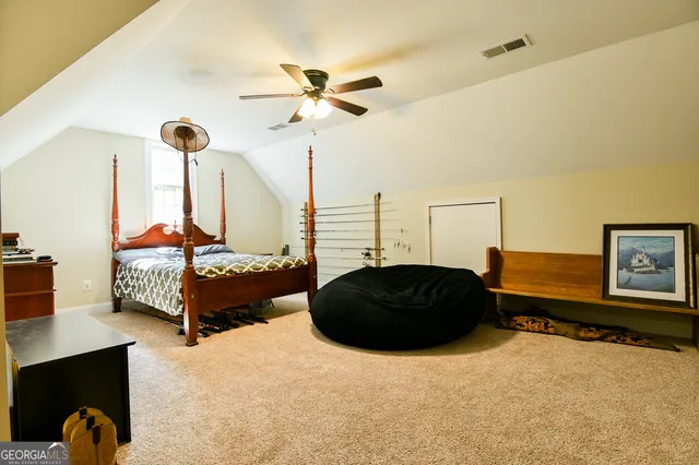a bedroom with a bed window and dresser