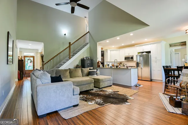 a living room with furniture and kitchen view