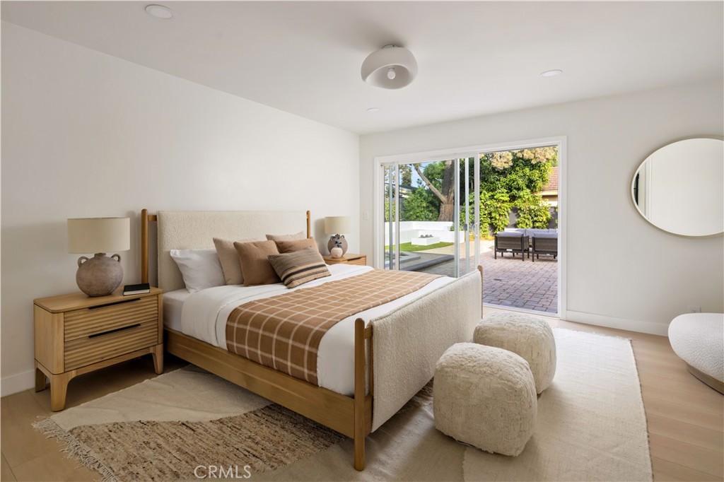 17841 Lucero Way Tustin, CA 92780 - Photo 19 of 39 a bedroom with a bed and wooden floor