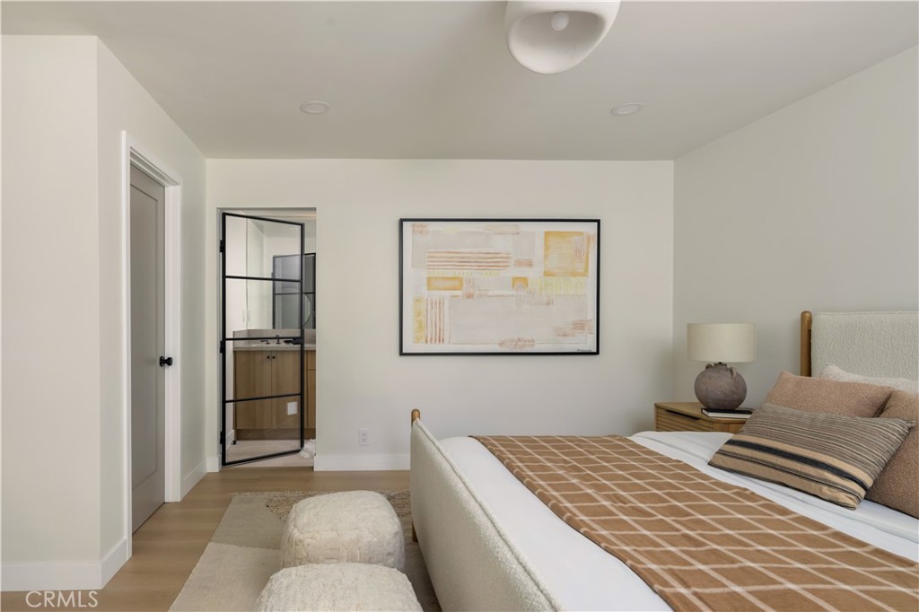 17841 Lucero Way Tustin, CA 92780 - Photo 20 of 39 a bedroom with a bed and a painting on the wall