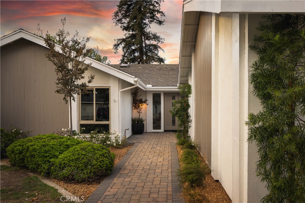 17841 Lucero Way Tustin, CA 92780 - Photo 2 of 39 a view of a house with a small yard plants and large tree