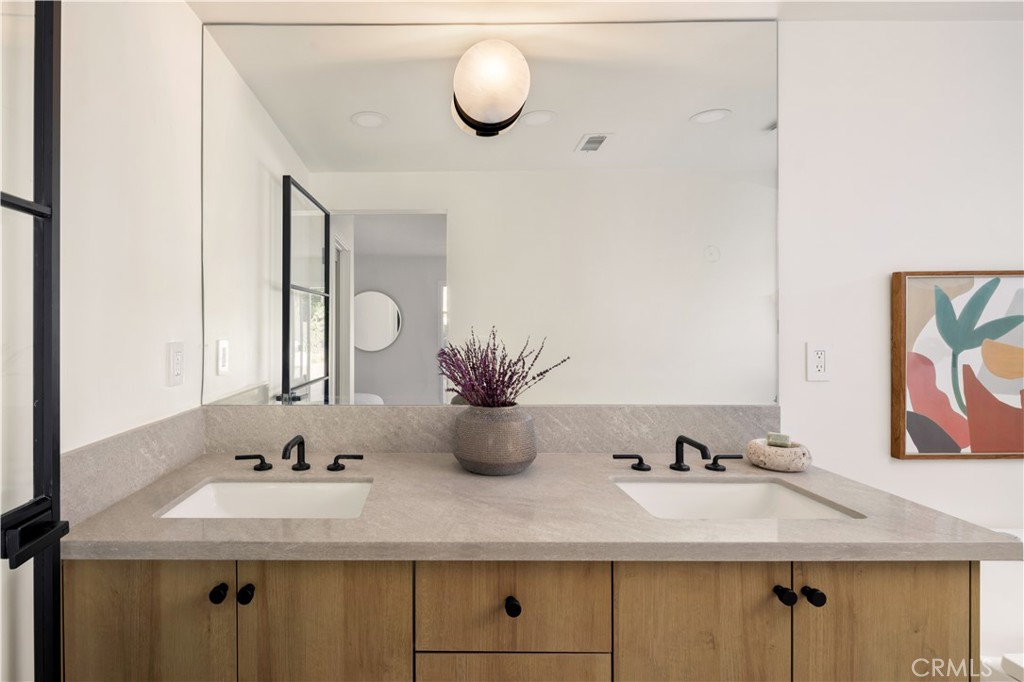 17841 Lucero Way Tustin, CA 92780 - Photo 22 of 39 a bathroom with a sink and mirror