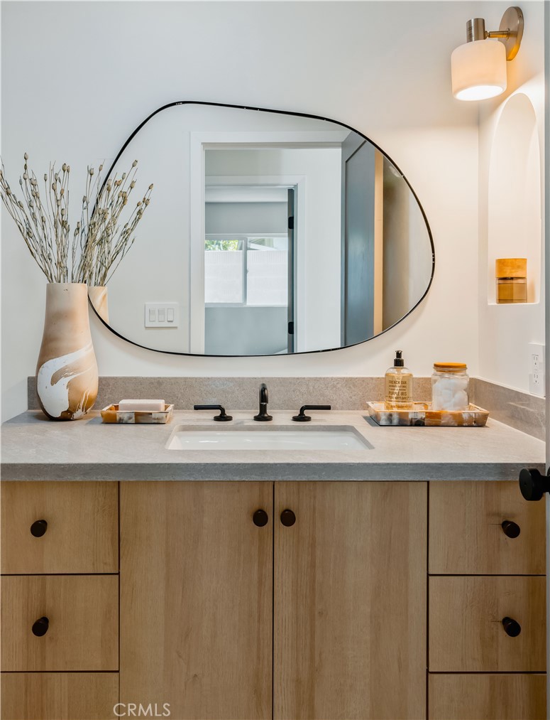 17841 Lucero Way Tustin, CA 92780 - Photo 26 of 39 a bathroom with a sink vanity and mirror