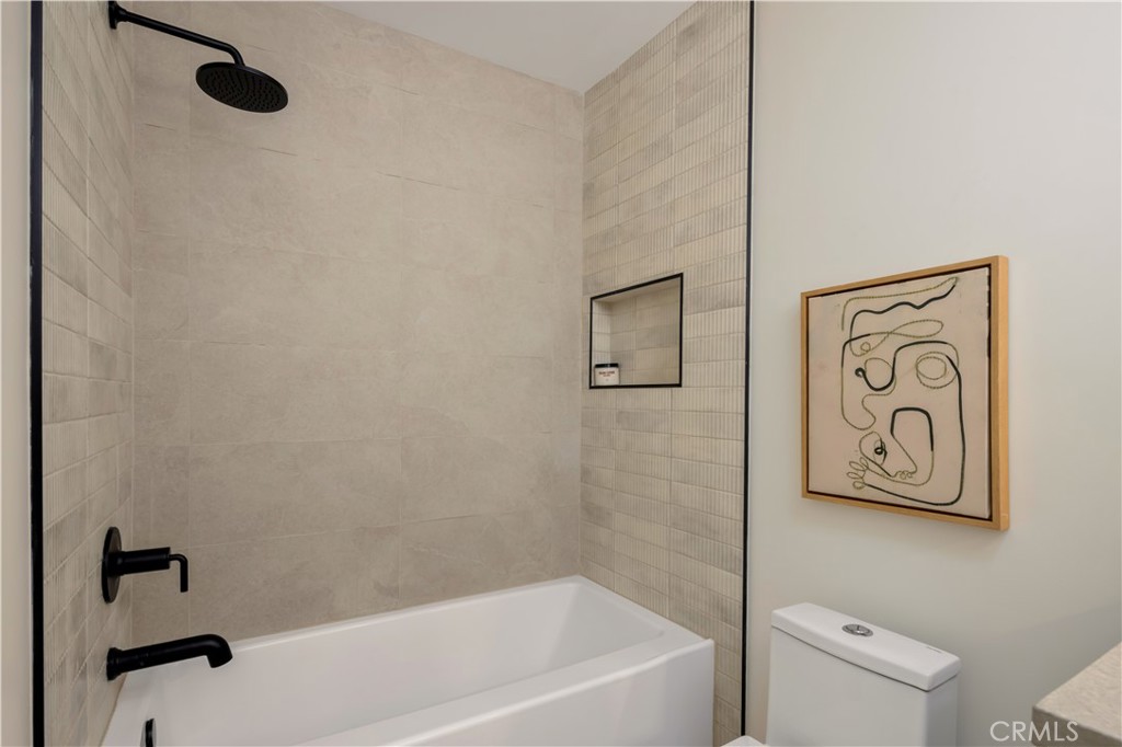 17841 Lucero Way Tustin, CA 92780 - Photo 27 of 39 a bathroom with a bathtub and shower