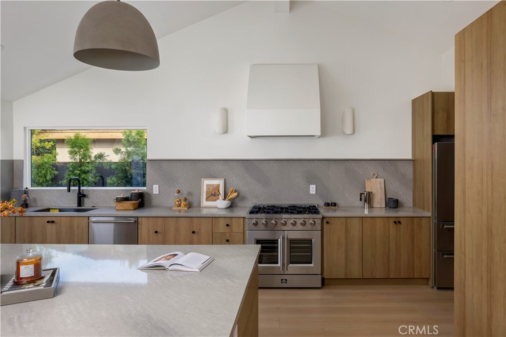 17841 Lucero Way Tustin, CA 92780 - Photo 9 of 39 a kitchen with stainless steel appliances a stove and a refrigerator
