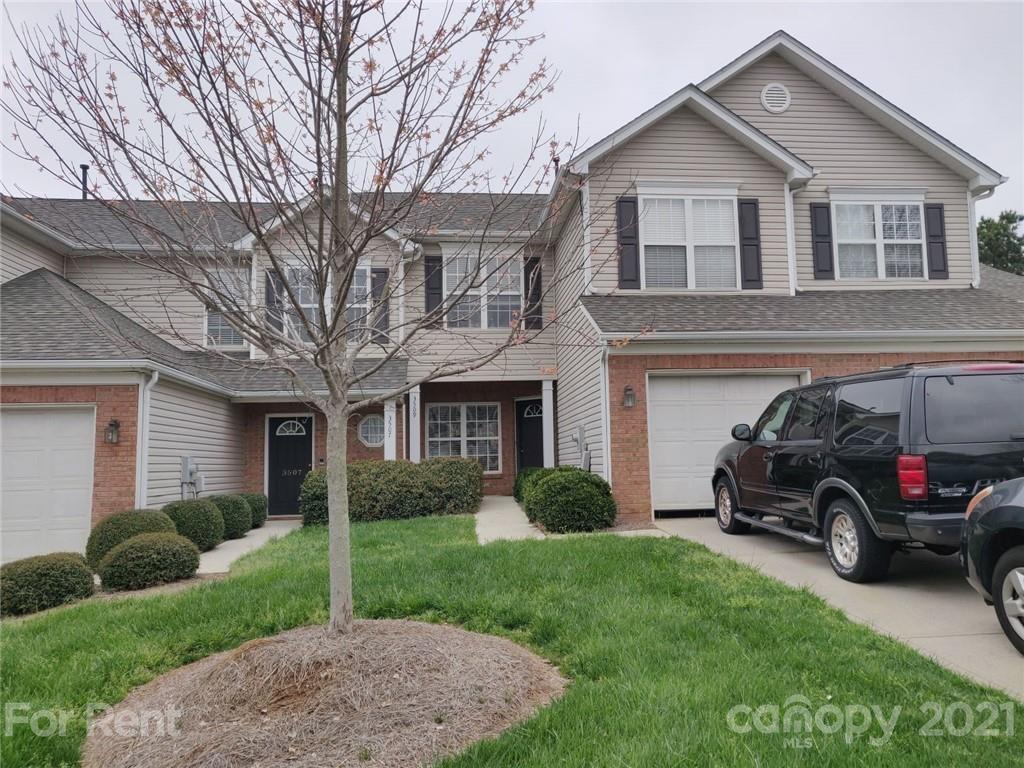 3509 Summerfield Ridge Lane, Unit 33 Matthews, NC 28105 - Photo 1 of 13 a car parked in front of a house and a yard