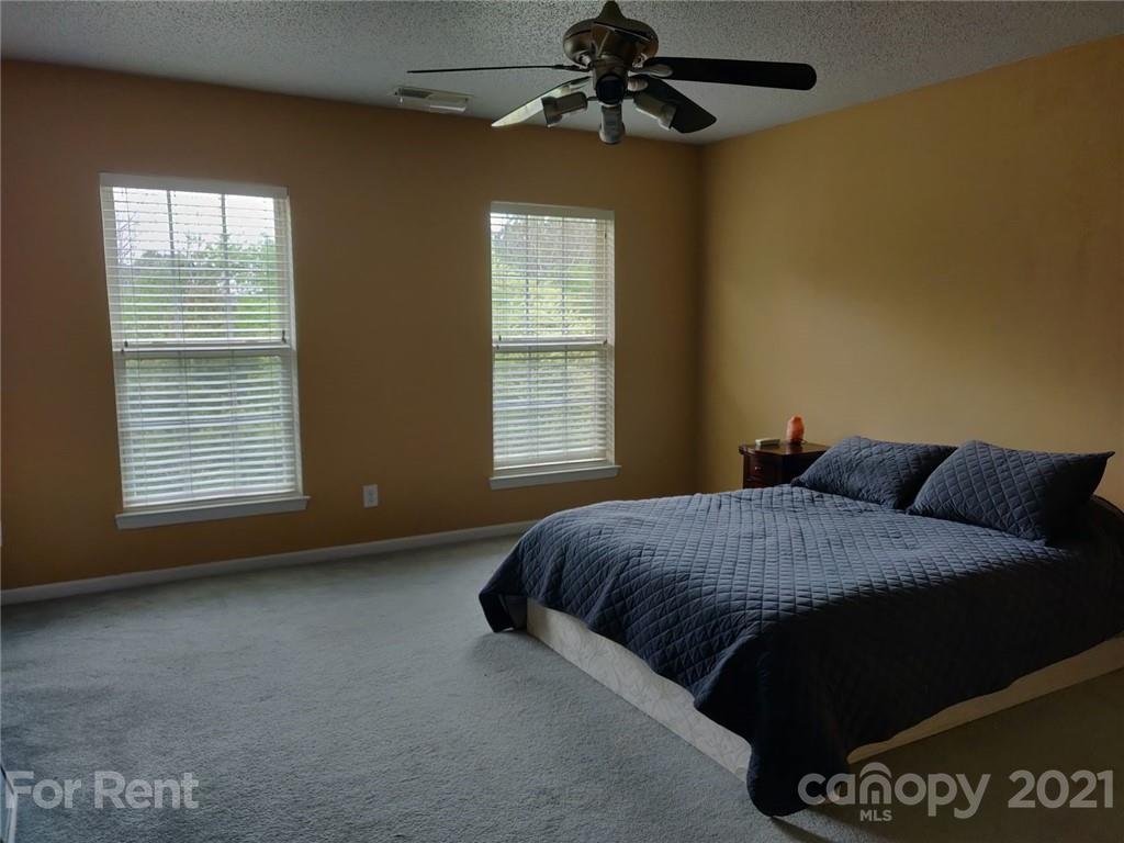 3509 Summerfield Ridge Lane, Unit 33 Matthews, NC 28105 - Photo 12 of 13 a bedroom with a bed and a window