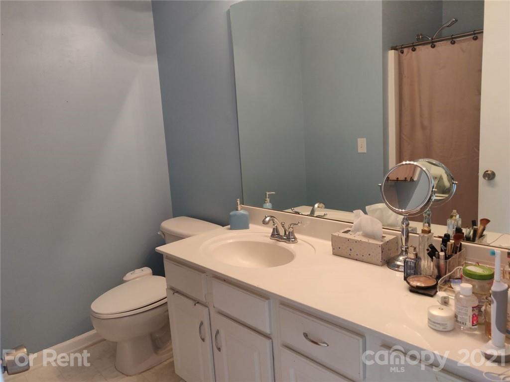 3509 Summerfield Ridge Lane, Unit 33 Matthews, NC 28105 - Photo 13 of 13 a bathroom with a toilet sink and mirror