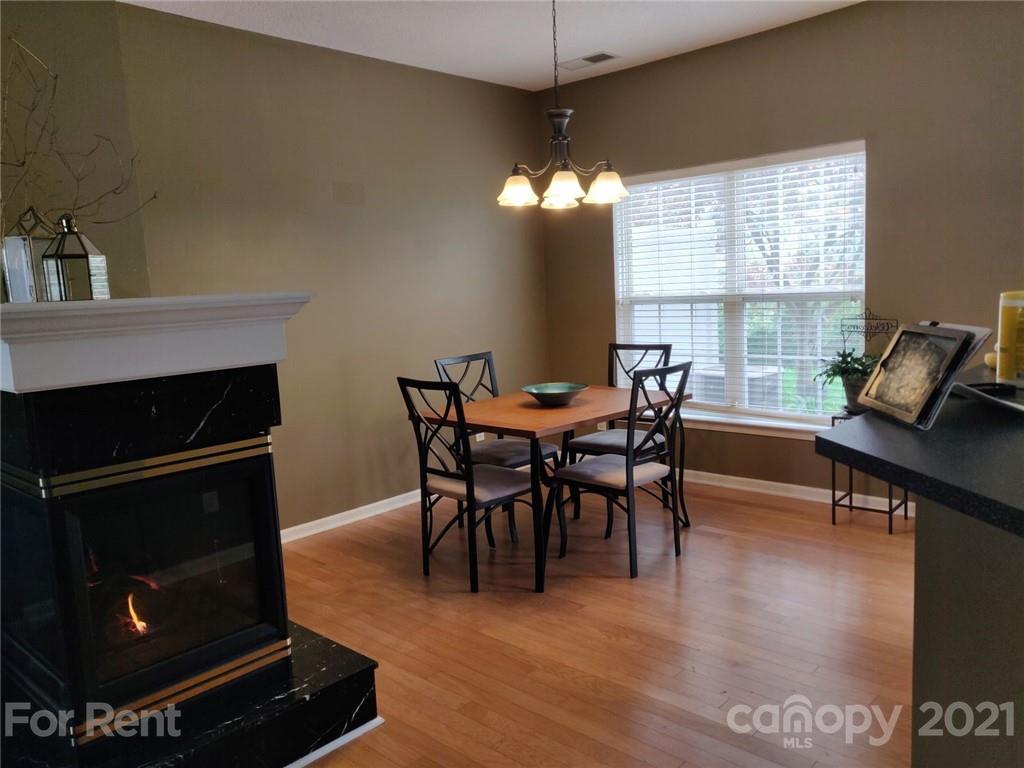 3509 Summerfield Ridge Lane, Unit 33 Matthews, NC 28105 - Photo 4 of 13 a view of a dining room with furniture window and wooden floor