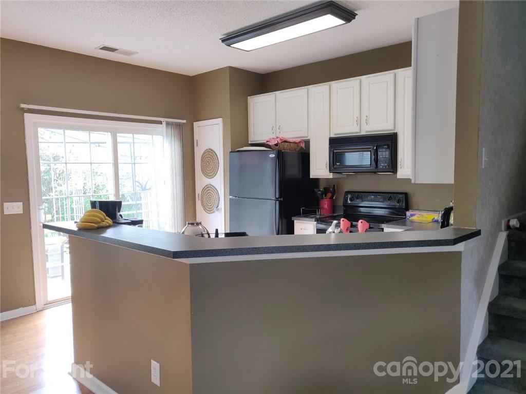 3509 Summerfield Ridge Lane, Unit 33 Matthews, NC 28105 - Photo 6 of 13 a kitchen with refrigerator and window