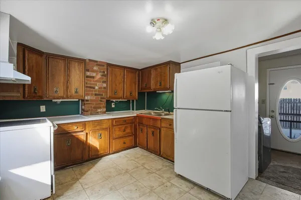 a kitchen with a sink stove and cabinets