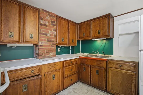 a view of a hallway with wooden floor and entryway