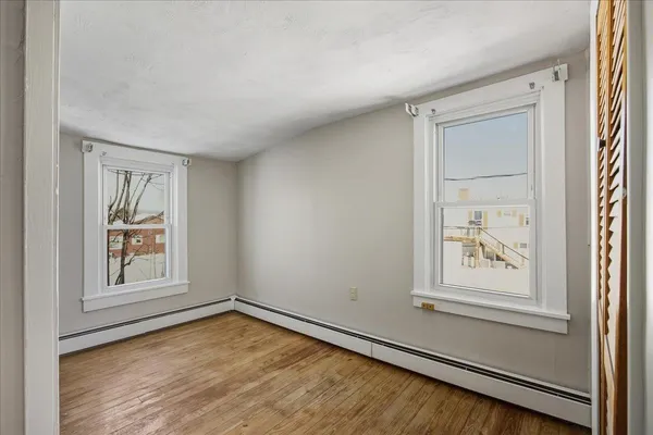 a bathroom with a toilet a sink a mirror and vanity