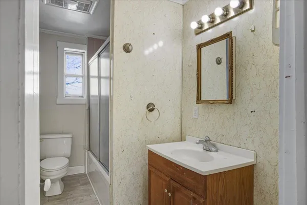 a bathroom with a sink toilet and shower