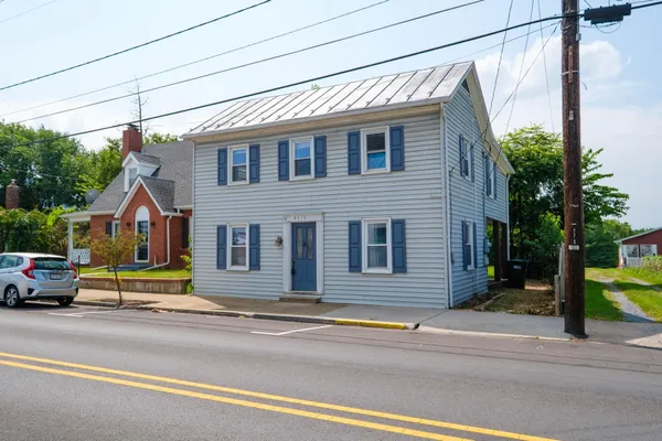 a view of empty room with wooden floor and fence