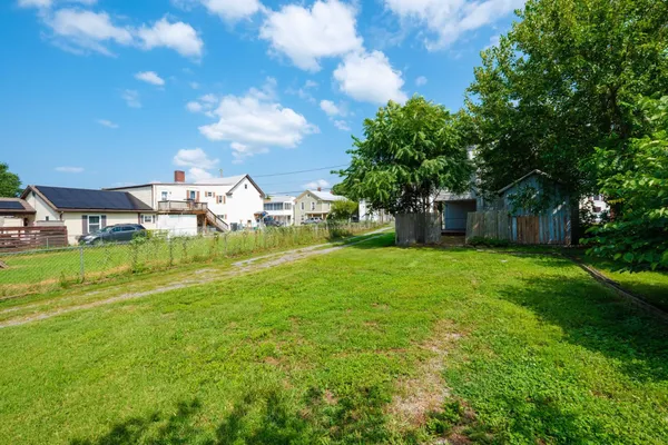 a view of entryway with wooden floor and stairs