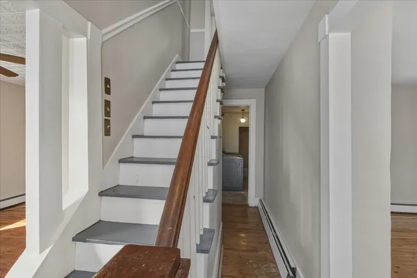 a view of entryway and hall with wooden floor