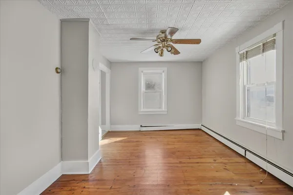 an empty room with a empty space and windows