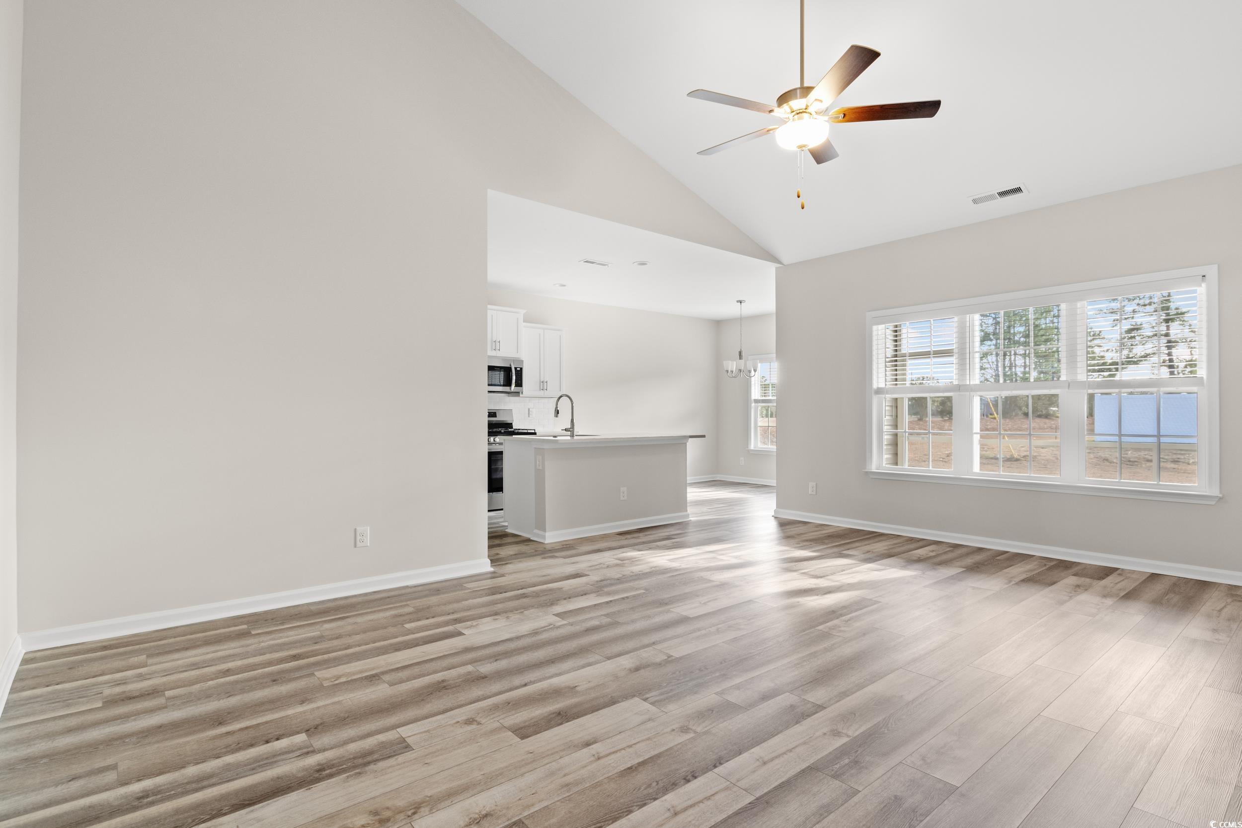 109 Lakota Loop Longs, SC 29568 - Photo 3 of 20 Unfurnished living room with sink, high vaulted ce