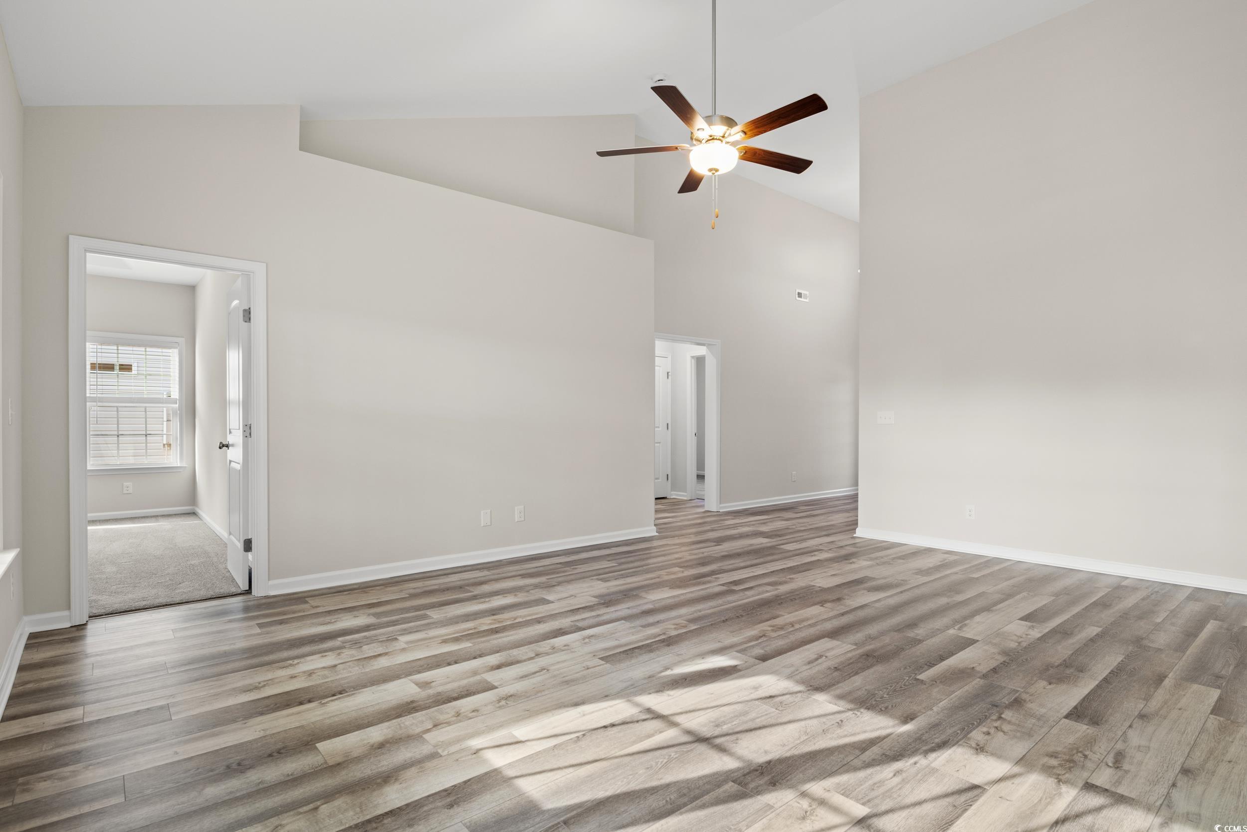 109 Lakota Loop Longs, SC 29568 - Photo 9 of 20 Unfurnished living room with ceiling fan, light wo