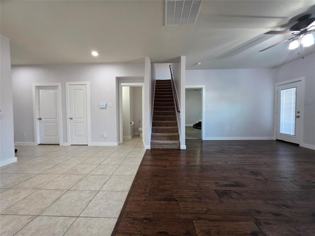 149 Ryan Street Anna, TX 75409 - Photo 8 of 38 an empty room with wooden floor and entryway