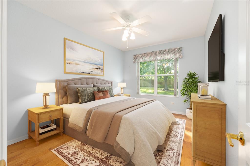 9019 Southeast 120th Loop Summerfield, FL 34491 - Photo 22 of 69 a bedroom with a bed a couch and a flat tv screen on dresser