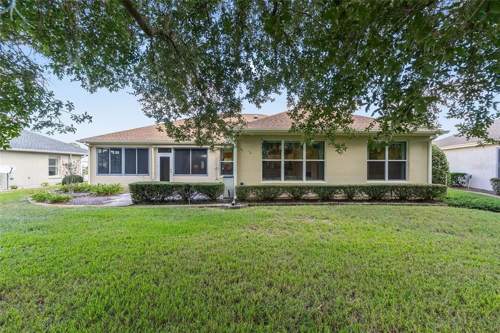 9019 Southeast 120th Loop Summerfield, FL 34491 - Photo 36 of 69 a front view of a house with a garden
