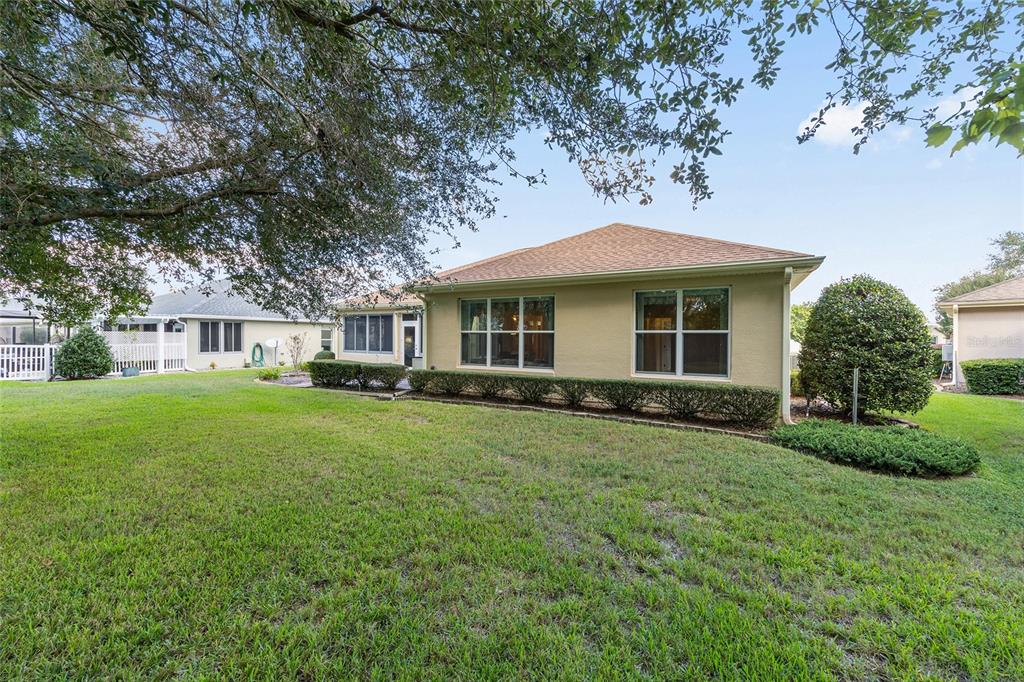 9019 Southeast 120th Loop Summerfield, FL 34491 - Photo 37 of 69 a front view of a house with a garden