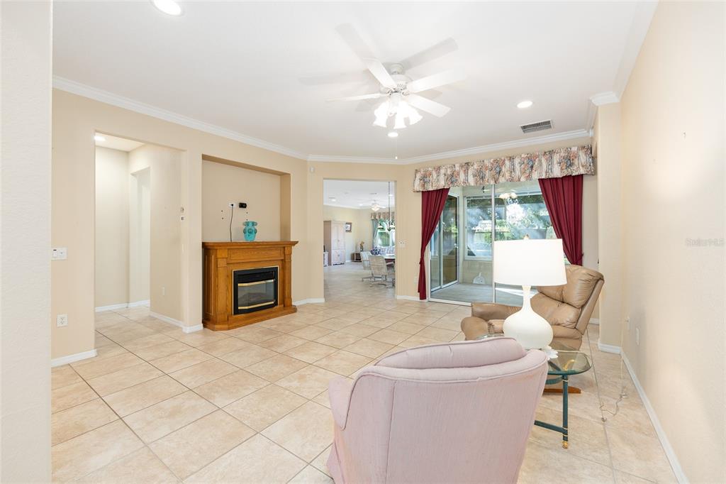 9019 Southeast 120th Loop Summerfield, FL 34491 - Photo 8 of 69 a living room with furniture and a fireplace