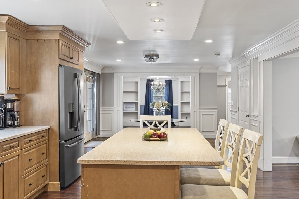 390 Cooper Road Northbridge, MA 01534 - Photo 11 of 34 a large white kitchen with a refrigerator a dining table and chairs