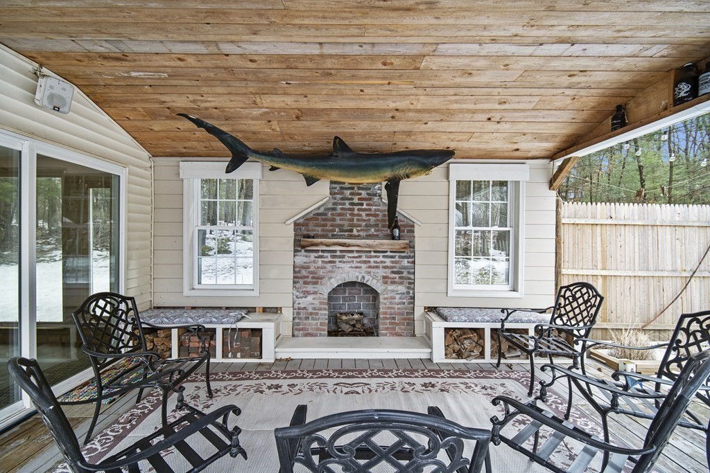 390 Cooper Road Northbridge, MA 01534 - Photo 16 of 34 a living room with furniture a fireplace and a table