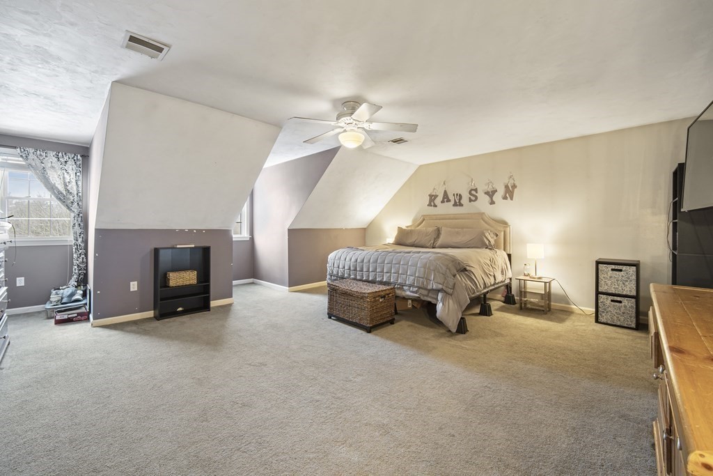 390 Cooper Road Northbridge, MA 01534 - Photo 25 of 34 a bedroom with furniture and a chandelier