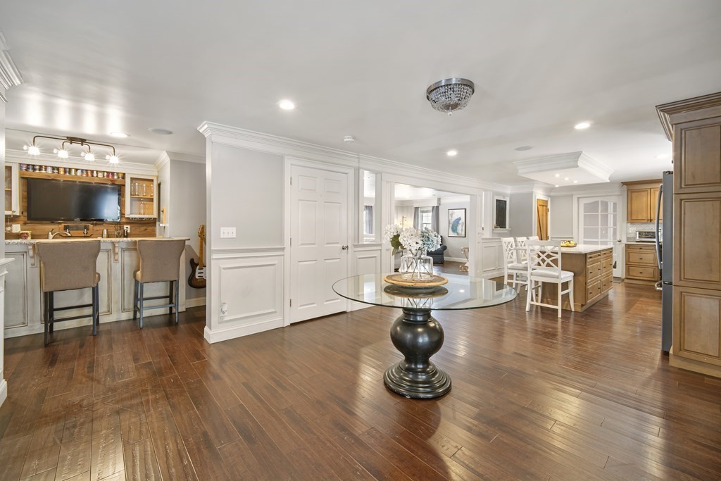 390 Cooper Road Northbridge, MA 01534 - Photo 4 of 34 a living room with furniture and a dining table with wooden floor