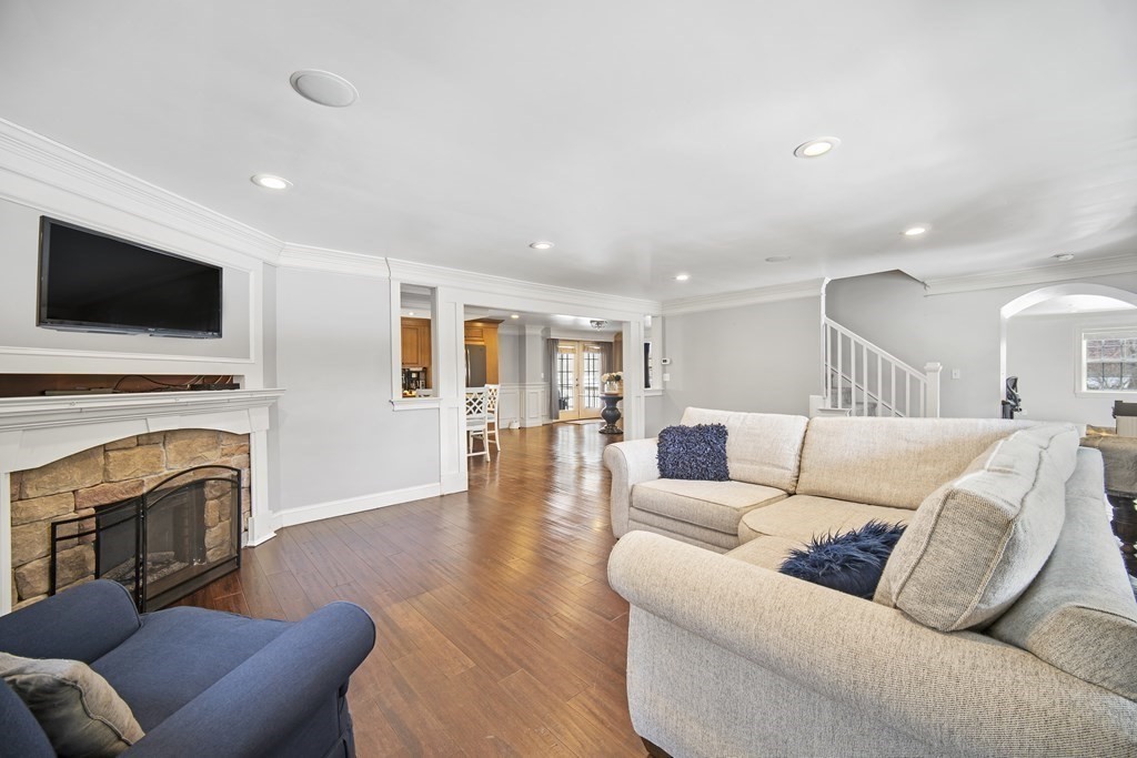390 Cooper Road Northbridge, MA 01534 - Photo 5 of 34 a living room with furniture a flat screen tv and a fireplace