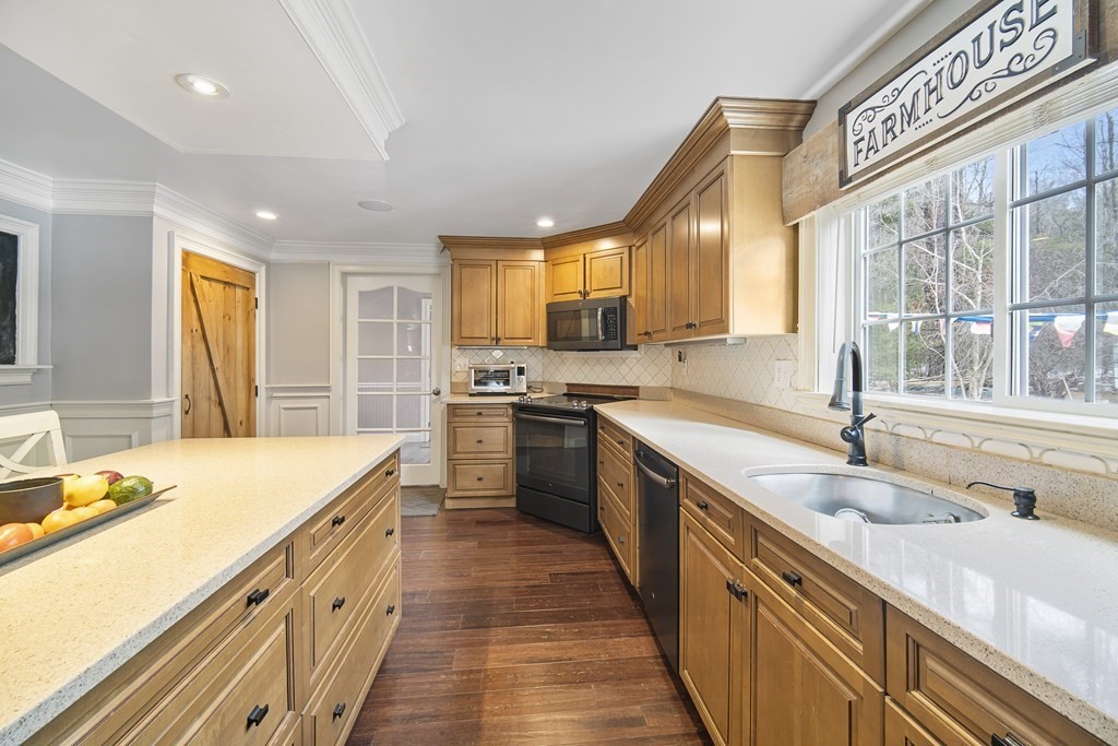 390 Cooper Road Northbridge, MA 01534 - Photo 8 of 34 a kitchen with a sink a stove cabinets and a wooden floor