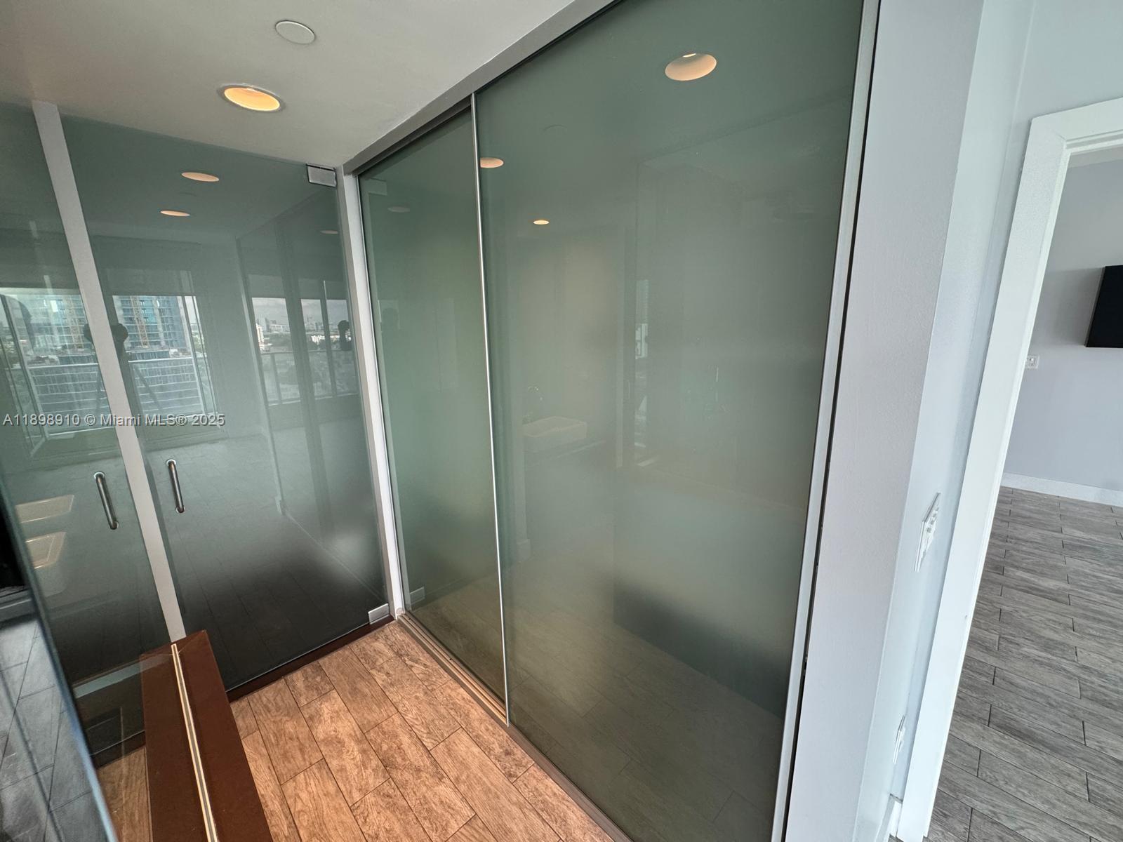 1040 Biscayne Boulevard, Unit 1106 Miami, FL 33132 - Photo 17 of 29 a bathroom with a glass door shower