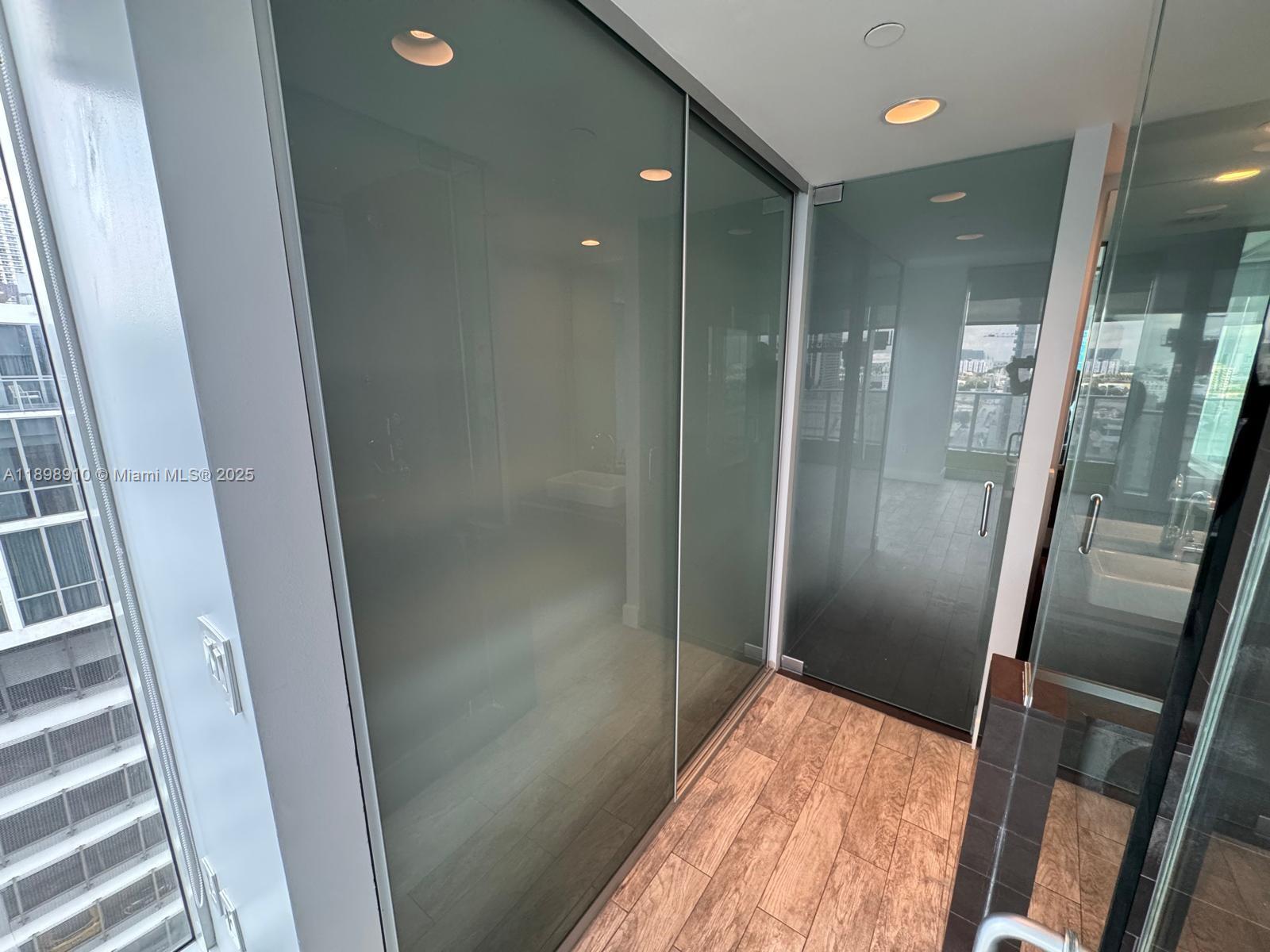 1040 Biscayne Boulevard, Unit 1106 Miami, FL 33132 - Photo 18 of 29 a bathroom with a shower and a sink