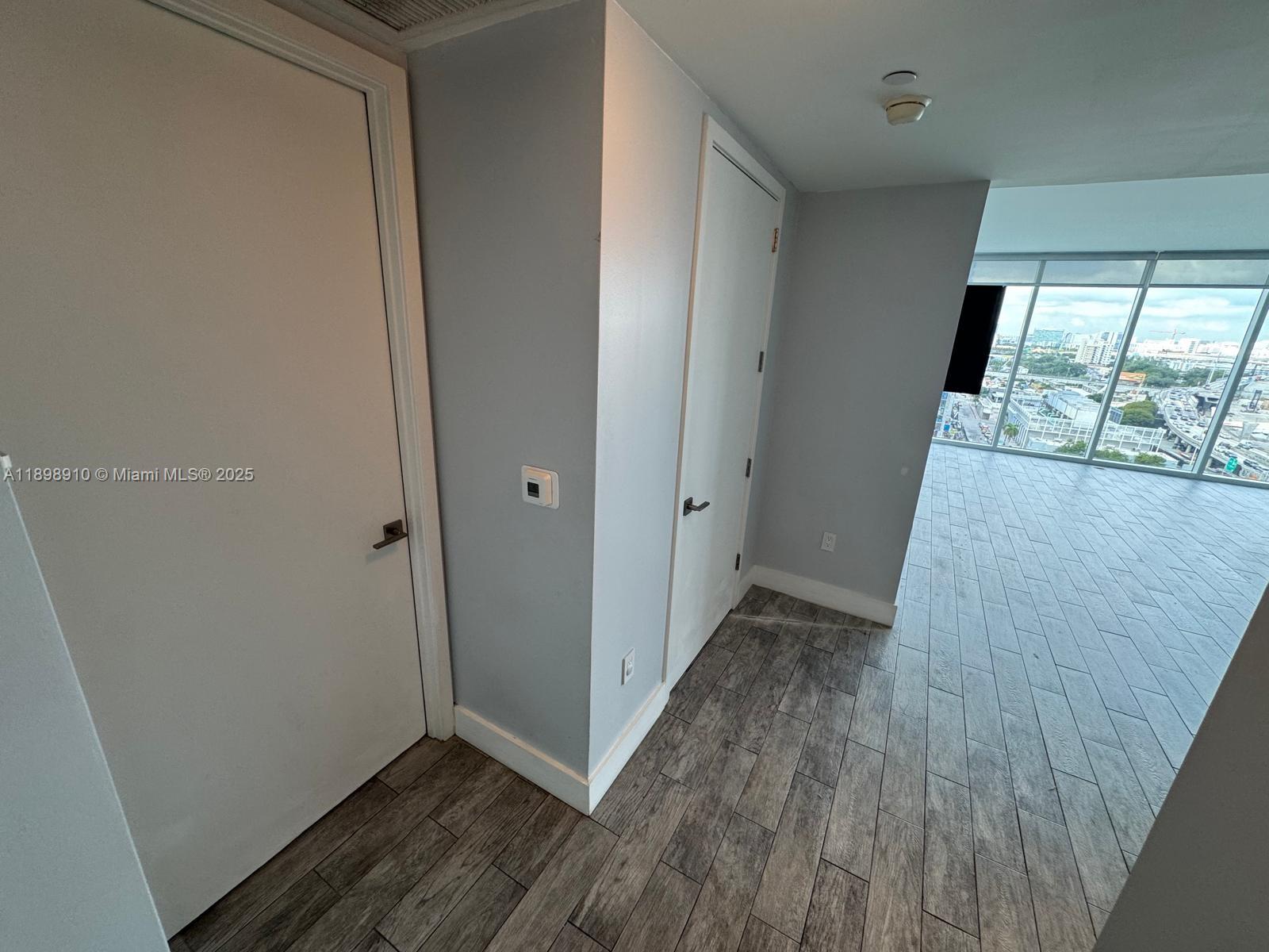 1040 Biscayne Boulevard, Unit 1106 Miami, FL 33132 - Photo 7 of 29 a view of hallway with wooden floor