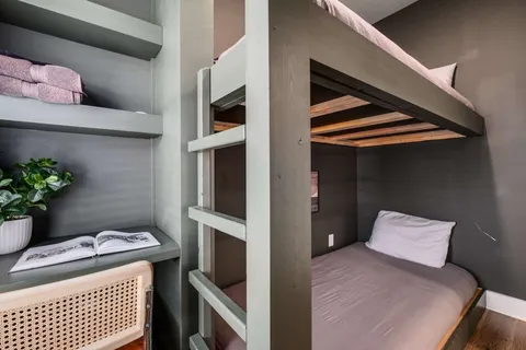 a bedroom with a bed and a potted plant