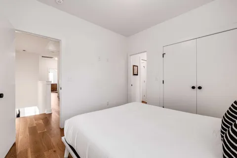 a bedroom with a bed and a table