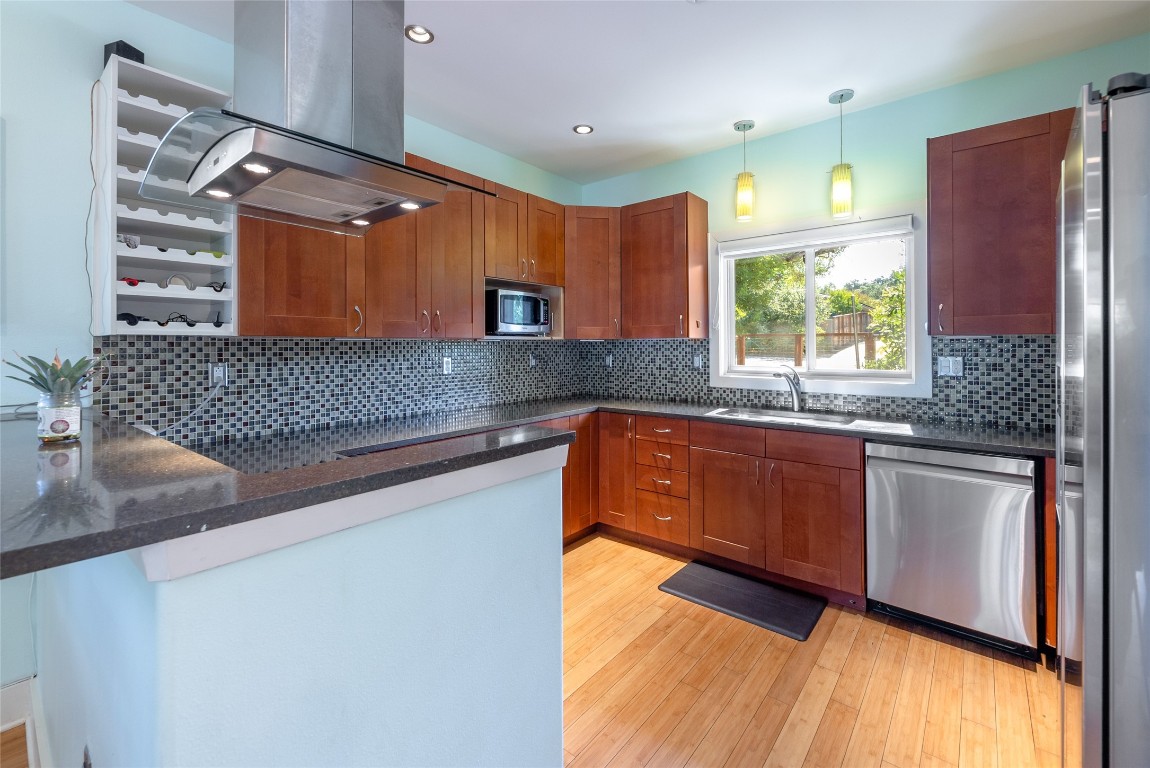 a kitchen with granite countertop a sink and a counter top space
