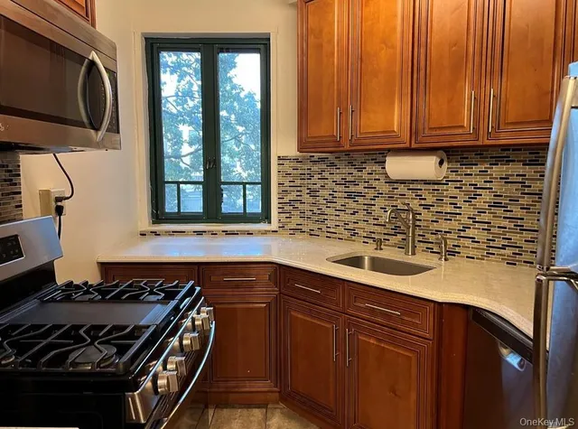 a kitchen with a sink stove and microwave