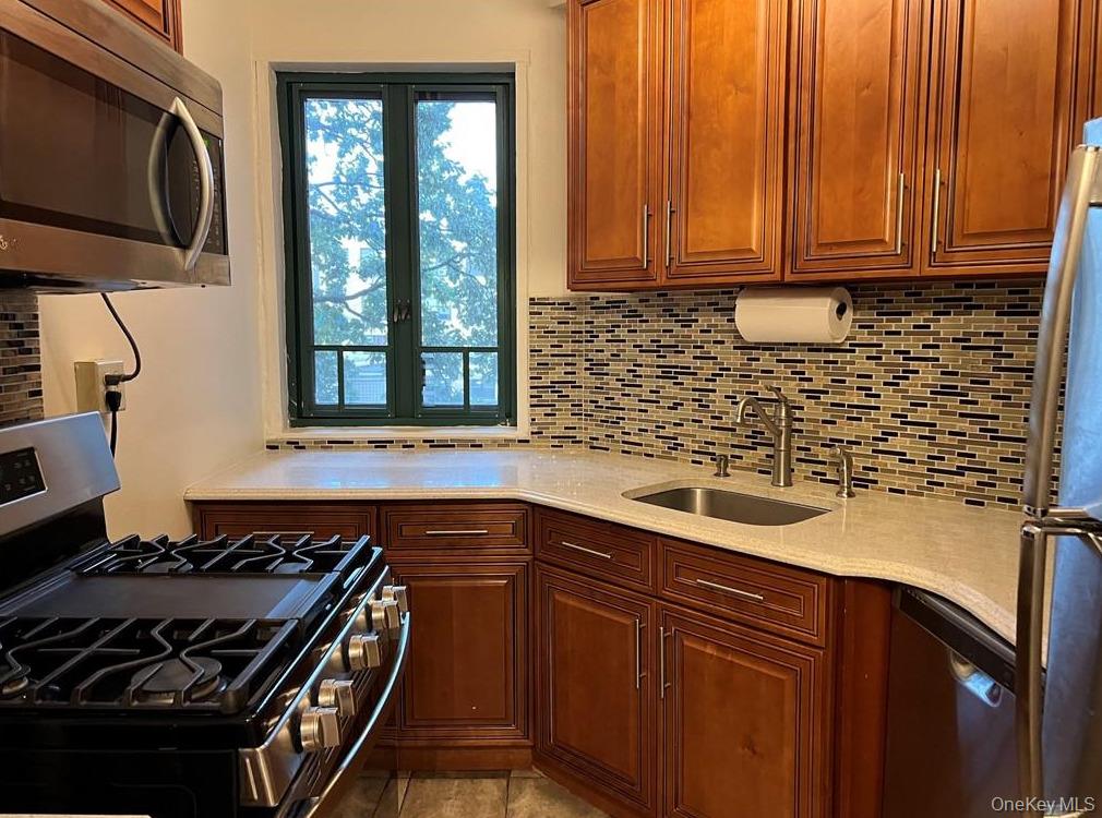 1735 Purdy Street, Unit 2B Bronx, NY 10462 - Photo 3 of 6 a kitchen with a sink stove and microwave