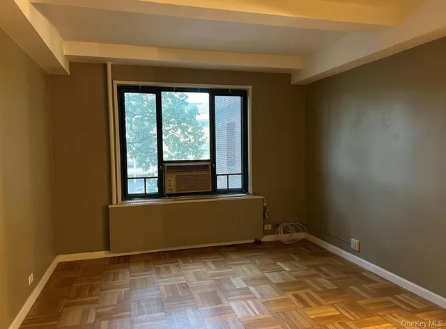 a view of a livingroom with an empty space and a window