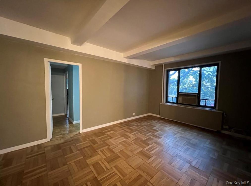 1735 Purdy Street, Unit 2B Bronx, NY 10462 - Photo 6 of 6 an empty room with wooden floor and windows