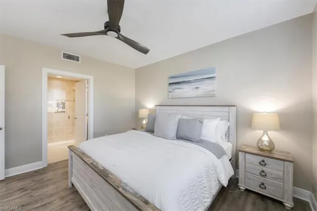 a bedroom with a bed and a night stand