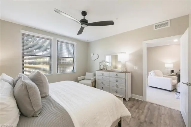a spacious bedroom with a bed and ceiling fan
