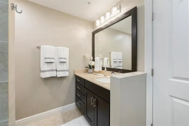 a bathroom with a sink vanity and mirror