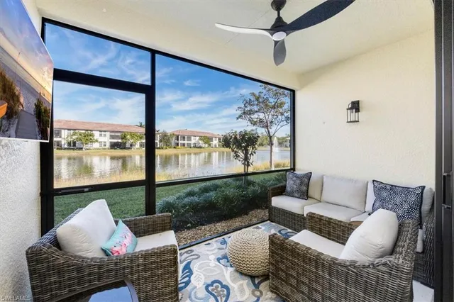 a living room with furniture and a floor to ceiling window
