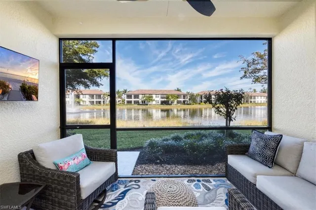 a living room with furniture and a floor to ceiling window